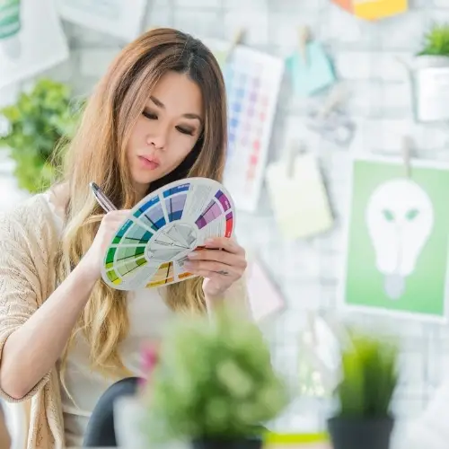 woman choosing brand colors from a color wheel